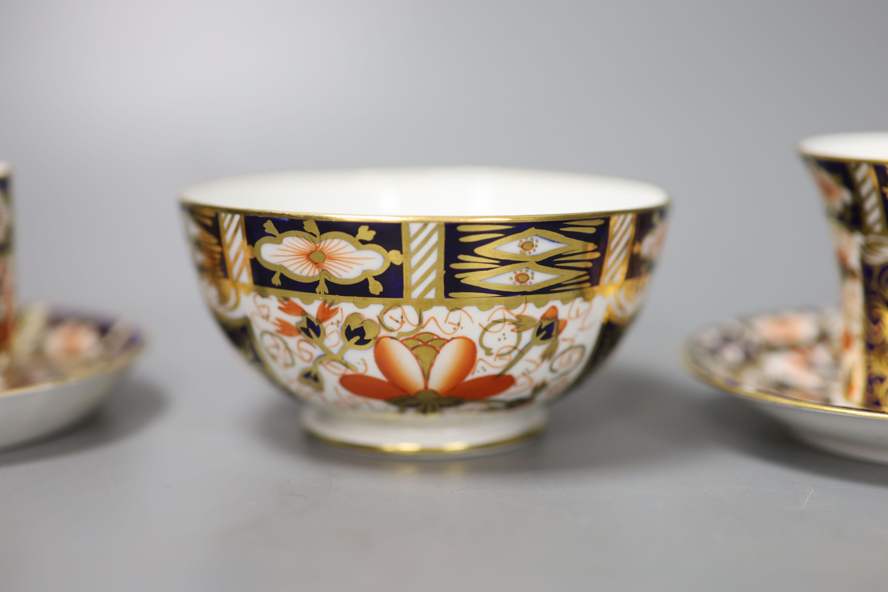 A pair of Royal Crown Derby coffee cups, imari pattern 2451, a coffee can and saucer and a sugar bowl